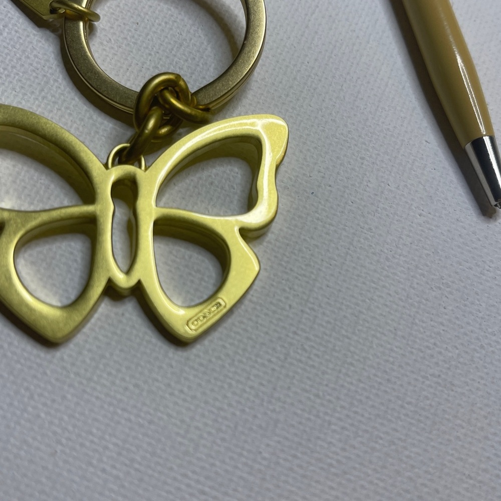 Coach Gold Butterfly Keychain and Cream Coach Pen - Picture 3 of 5